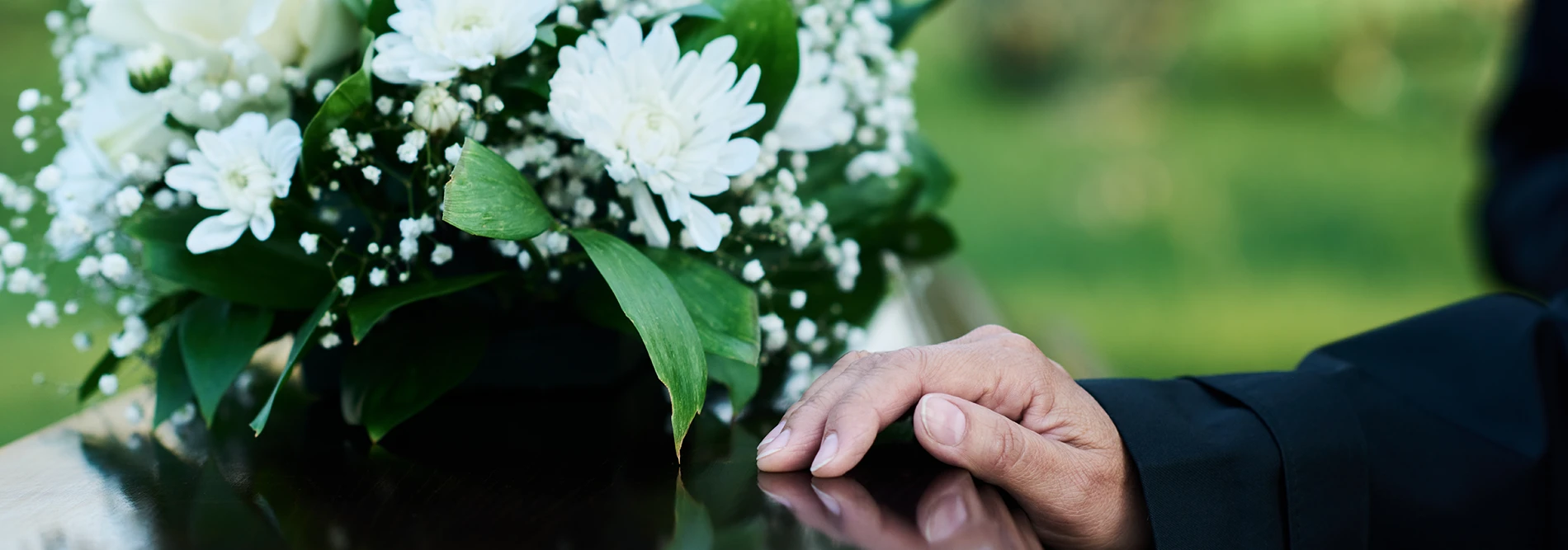 hand rested on top of a casket
